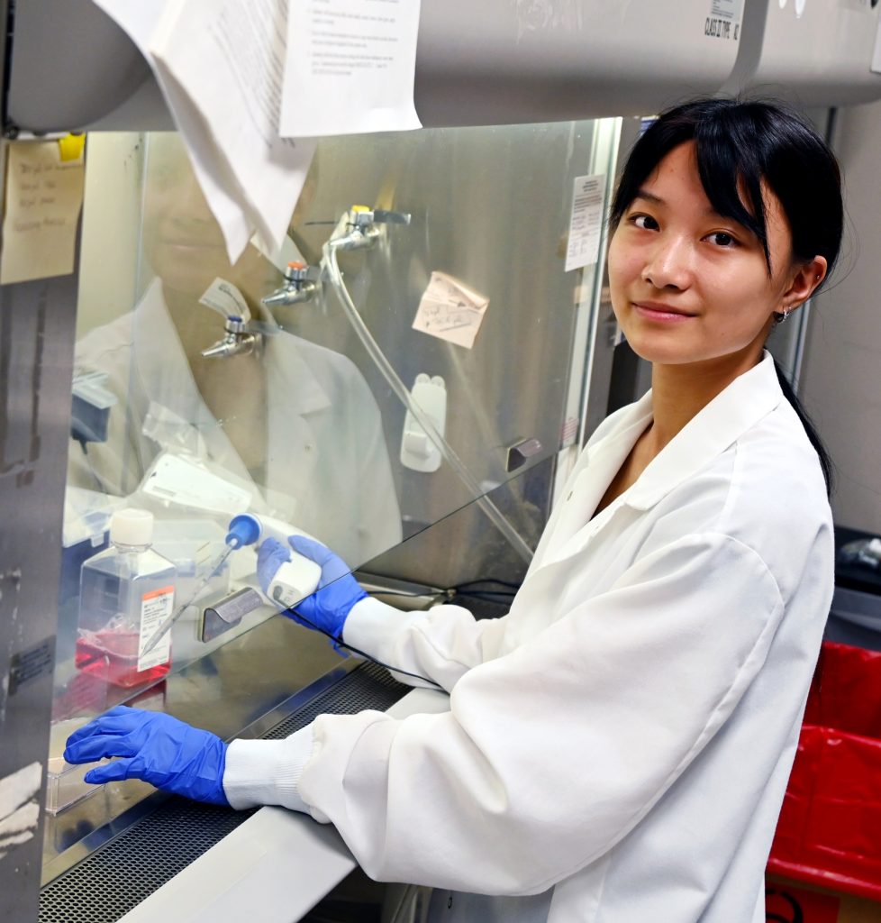 Un estudiante de secundaria que participa en un programa de académicos de verano aprende técnicas de laboratorio adecuadas.