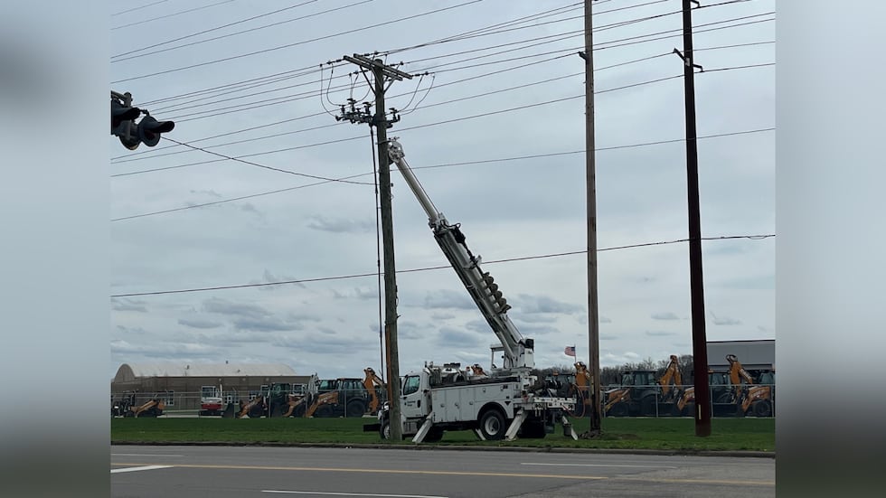 Cuadrillas trabajando para reparar un poste de servicios públicos a lo largo de Lynch Rd.